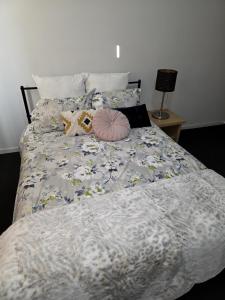 a bed with two stuffed animals on top of it at Four-bedroom house in Gungahlin +3 photos
