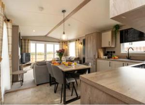a kitchen and living room with a table and chairs at ScottishHighlands in Boat of Garten +16 photos