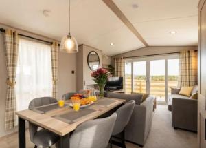 a dining room and living room with a table and chairs at ScottishHighlands in Boat of Garten