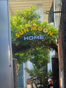 a sun moom home sign in front of a building at homestay SunMoon 14 Lê Lợi in Phan Thiet