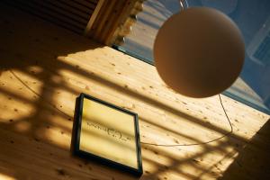 a mirror on a wall with a lamp and a light fixture at A&A Okayama in Okayama