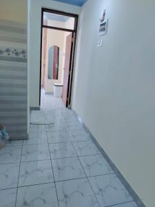 a hallway of a house with a tile floor at Mwangaza in Mombasa