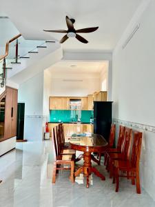 a kitchen with a table and chairs and a ceiling fan at Villa 1985 in Buon Ma Thuot