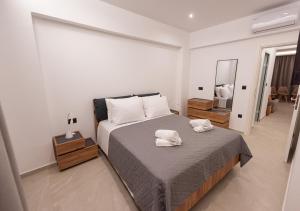 a bedroom with a bed with two towels on it at Sinani Villas Rhodes in Afantou +43 photos