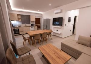 a kitchen and living room with a table and a couch at Sinani Villas Rhodes in Afantou
