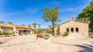 a church with a brick road and a building at Holiday Marina Resort in Grimaud