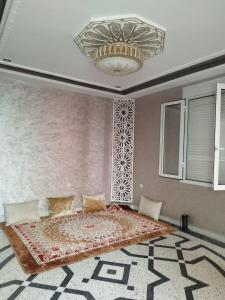 a bedroom with a large bed and a chandelier at Luxurious mountain villa avec wifi in El Ksiba
