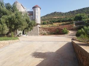 an empty parking lot in front of a building at Luxurious mountain villa avec wifi in El Ksiba