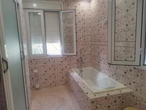 a bathroom with a tub and a sink and a window at Luxurious mountain villa avec wifi in El Ksiba +31 photos