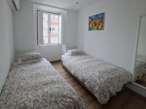 En eller flere senge i et værelse på Casa do Coronel de Alcochete