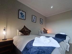a bedroom with two beds with towels on them at Leopolds Rest in Prieska