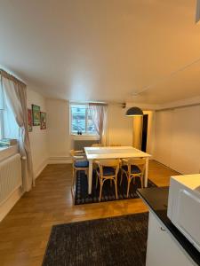 a kitchen and dining room with a table and chairs at Aurora Apartment 7 in Kiruna