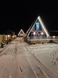 a cabin in the snow at night at AFrame Shahdag in Qusar