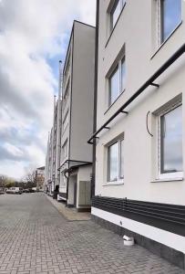a row of white buildings on a brick street at New apartment Căușeni in Căuşeni