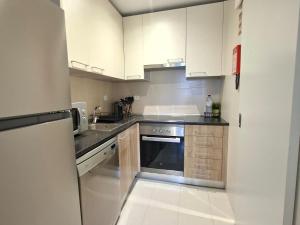 a kitchen with white cabinets and a stainless steel appliance at Casa do Coronel de Alcochete in Alcochete