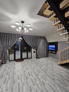 a large room with a ceiling with curtains and a television at AFrame Shahdag in Qusar