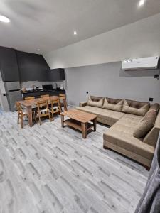 a living room with a couch and a table at AFrame Shahdag in Qusar