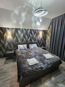 a bedroom with a bed with two towels on it at AFrame Shahdag in Qusar