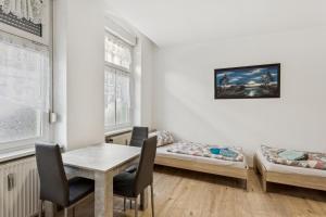 ein Zimmer mit zwei Betten und einem Tisch und Stühlen in der Unterkunft Büchner 52-1 in Gera