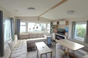 a living room with a couch and a table at Beach Resort Kamperland - 1152 in Kamperland