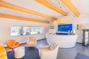 a waiting room with chairs and a counter at Holiday Marina Resort in Grimaud