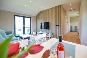 a living room with a bottle of wine on a table at Sun & Garden View in Oświęcim