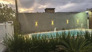 a swimming pool in a backyard with a fence at Casa praia in Capão da Canoa
