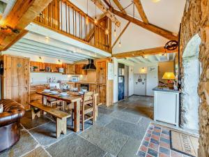 a kitchen and dining room with a table and chairs at 4 Bed in Llanfechell 90258 in Llanfechell