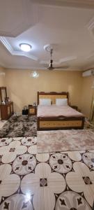 a bedroom with a large bed in a room at BTourays Rentals in Yundum