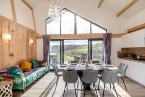 a dining room with a table and a couch at 4 Bed in Berriew oc-t31114 in Berriew