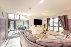 a living room with a couch and a tv at 4 Bed in Berriew oc-t31114 in Berriew
