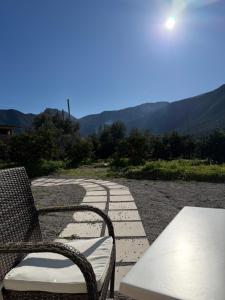 a patio with two chairs and a table with a view at Marathias Home in Leonidion