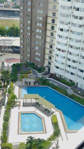 an overhead view of a pool in front of tall buildings at Oregano Suite- Avida Towers Aspira 2 in Sampong