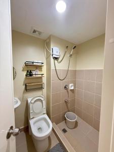 a bathroom with a toilet and a shower at Oregano Suite- Avida Towers Aspira 2 in Sampong +7 photos