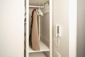 a closet with a towel hanging on a rack at Stylish smart studio in Tallinn