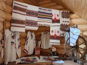 a room with a wall with a bunch of blankets and patterns at Stream House in Lopushnoye