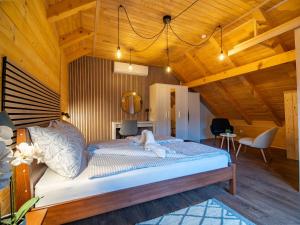 a bedroom with a bed with a dog laying on it at Wooden Villa Old Oak Plitvice Lakes in Seliste Dreznicko