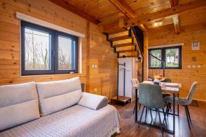 a living room with a couch and a table at Wooden Villa Old Oak Plitvice Lakes in Seliste Dreznicko