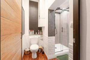 a small bathroom with a toilet and a shower at comme un air de chez soi in Calais +28 photos