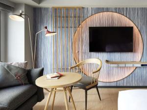 a living room with a table and a couch at Mercure Kyoto Station in Kyoto
