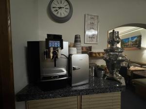 a counter with a coffee maker and a coffee machine at Hotel am Rosenbad in Fulda