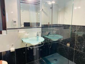 a bathroom with two sinks and a mirror at Breathtaking Valletta Harbour View - Exclusive in Sliema +39 photos