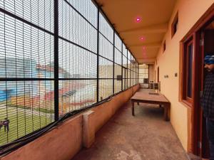 a room with a bench in front of a large window at The Laxman Palace in Ayodhya
