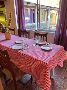 a table with a red and white checkered table cloth at Casa De Piedra Le Petit Chalet in San Clemente