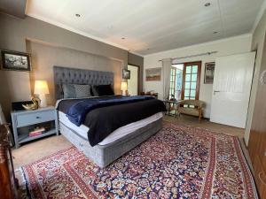 a bedroom with a large bed and a rug at The Little Mongrel Deluxe Space Bryanston in Johannesburg +13 photos