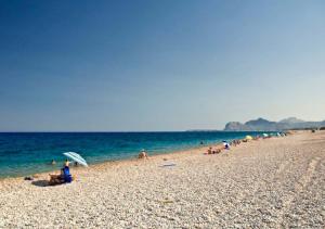 a group of people on a beach with the ocean at Sinani Villas Rhodes in Afantou