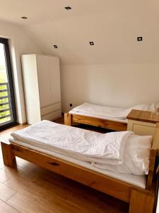 a bedroom with two beds in a room at Willa Rytel in Rytel
