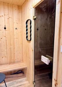 a wooden sauna with a black snake in it at Willa Rytel in Rytel +27 photos