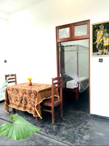 a room with a table and chairs and a window at silent beach House For Ever in Tangalle +25 photos