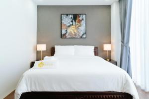 En eller flere senge i et værelse på Annam Saigon Home